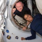 Os astronautas do Boeing Crew Flight Test da NASA (de cima) Butch Wilmore e Suni Williams posam em 13 de junho de 2024 para um retrato dentro do vestíbulo entre a porta dianteira do módulo Harmony da Estação Espacial Internacional e a nave espacial Starliner da Boeing. Crédito: NASA